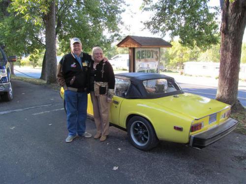 happy couple with yellow sports car - guests at rutting ridge motel and cabins in alma wisconsin